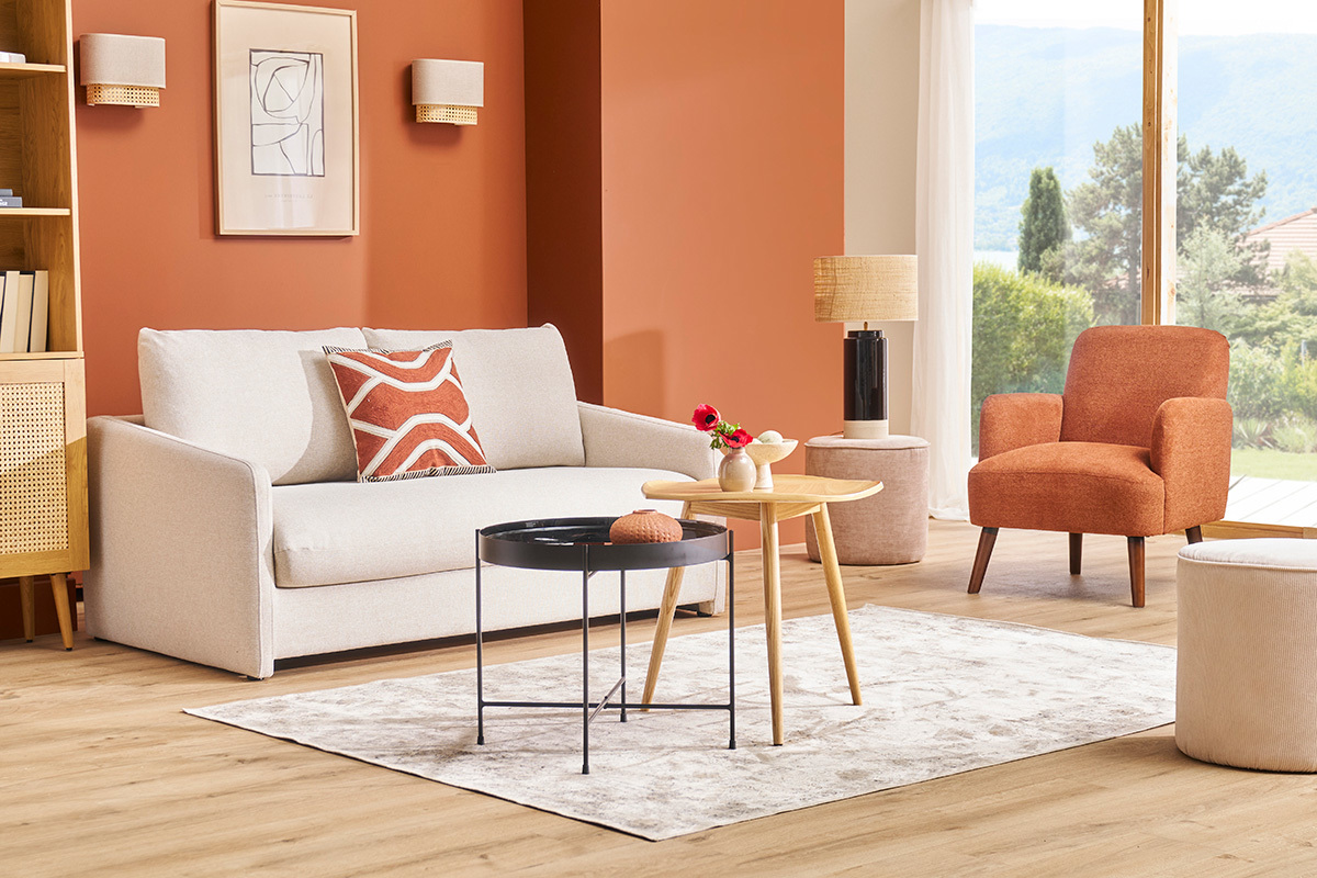 Canap� convertible beige cr�me PAULIN dans un salon moderne avec fauteuils et tables.
